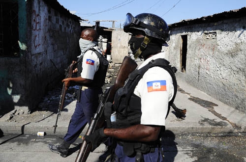 Haitian policemen search for runaway prisoners in Port-au-Prince, capital of Haiti, January 28, 2010.
