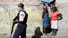 A Haitian policeman searches for runaway prisoners in Port-au-Prince, capital of Haiti, January 28, 2010.