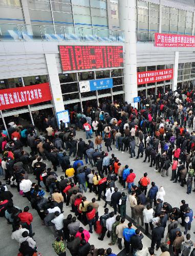 Passengers queue to buy tickets at the Fuzhou Railway Station in Fuzhou, capital of southeast China's Fujian Province, January 30, 2010. China's railways are expected to transport 210 million passengers during the 40-day travel peak starting from January 30, as people return home for family reunion in the traditional Spring Festival beginning from Feb. 14 this year and then go back to workplaces.