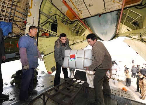 Chinese workers load emergency aid materials onto a transport plane at Zhengding International Airport in Shijiazhuang, capital of north China's Hebei Province, January 31, 2010. 