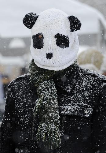 A man wearing a panda head-shaped hat attends a farewell party for giant panda Tai Shan at the National Zoo in Washington D.C., the United States, January 30, 2010.