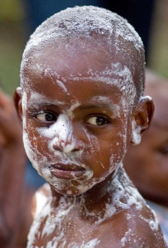 An orphan is taking a bath in Port-au-Princes, capital of Haiti, January 30, 2010. 