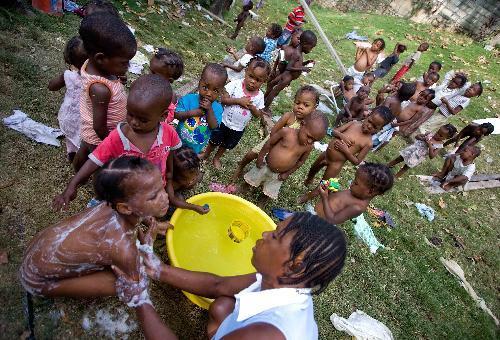 Orphans are taking their bath in Port-au-Princes, capital of Haiti, January 30, 2010. Before the deadly earthquake, there were nearly 100,000 orphans in Haiti.