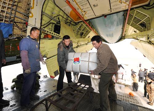 Chinese workers load emergency aid materials onto a transport plane at Zhengding International Airport in Shijiazhuang, capital of north China's Hebei Province, January 31, 2010.