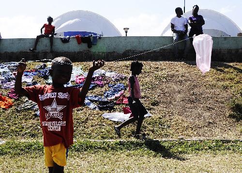  boy flies a plastic bag-made kite in Port-au-Prince, capital of Haiti, February 1, 2010.