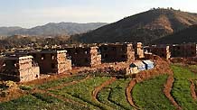 The picture taken on February 2, 2010 shows new houses about to be completed in Guantun Village in Yao'an County, southwest China's Yunnan Province.