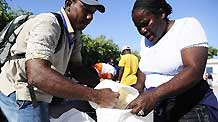 A local resident gets food at a food distribution site opened by United Nations agency the World Food Program (WFP) in Port-au-Prince, capital of Haiti, on February 2, 2010.