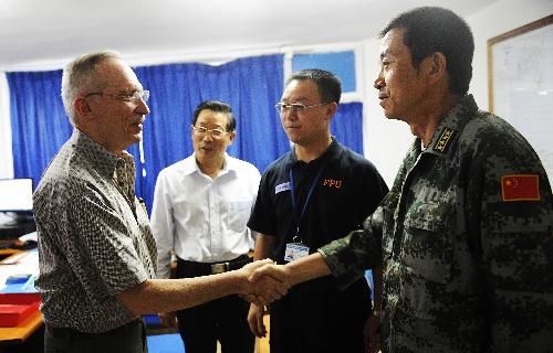 Edmond Mulet (1st L), acting special representative of the Secretary-General for Haiti, shakes hands with the leader of Chinese medical team Liu Wendou (1st R) in Port-au-Prince, capital of Haiti, on February 2, 2010. 