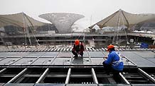 Technicians equip solar energy panels on the China Pavilion for 2010 World Expo in east China's Shanghai Municipality, February 3, 2010.