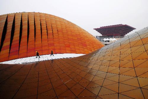 Workers walk on the roof of the Pavilion of the United Arab Emirates in the Shanghai World Expo Park in east China's Shanghai Municipality, February 3, 2010. 