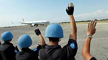 Members of the Chinese anti-riot team in Haiti wave goodbye to the Chinese medical team at the international airport in Port-au-Prince, capital of Haiti, February 8, 2010.