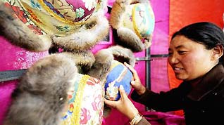 A woman sells traditional hats at a market in Lhasa, capital of southwest China's Tibet Autonomous Region, Feb. 11, 2010, during the preparation for the Spring Festival and Tibetan Losar.