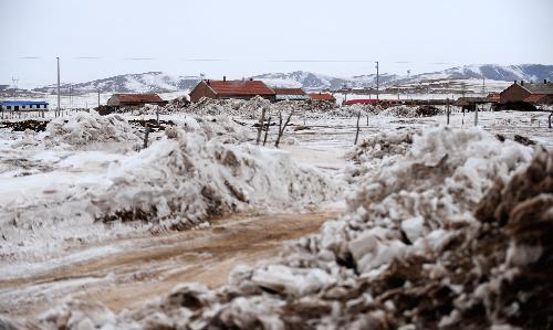 Snow is seen near a village in Xilingol League of north China's Inner Mongolia Autonomous Region, Feb. 11, 2010. With the help from central and local governments, which had spent more than 136 million yuan (some US$20 million) to relieve the snow disaster in Inner Mongolia until January, more than 2 million people affected by the disaster try their best to overcome the difficulties and prepare for the Spring Festival which falls on Feb. 14.