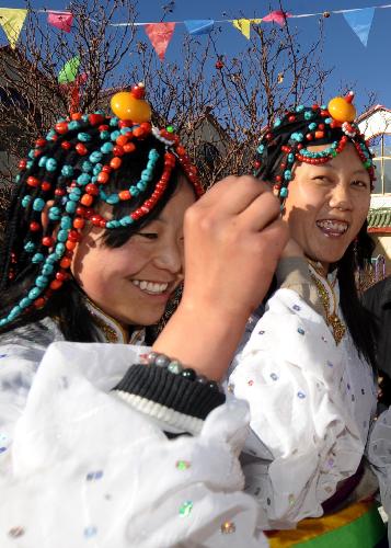 Two girls of the Tibetan ethnic group attend a celebration for the lunar New Year of the Tiger according to the Tibetan calendar, in Lhasa, capital of southwest China's Tibet Autonomous Region, Feb. 14, 2010.