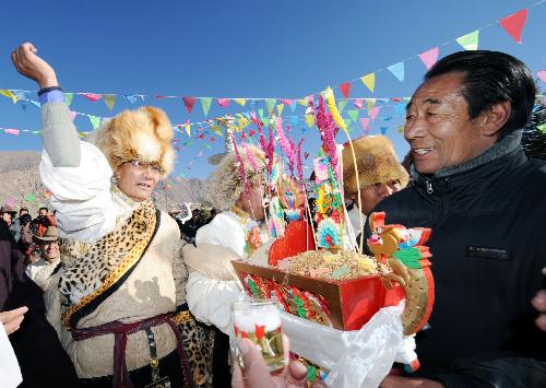 People of the Tibetan ethnic group attend a celebration for the lunar New Year of the Tiger according to the Tibetan calendar, in west Lhasa, capital of southwest China's Tibet Autonomous Region, Feb. 14, 2010.
