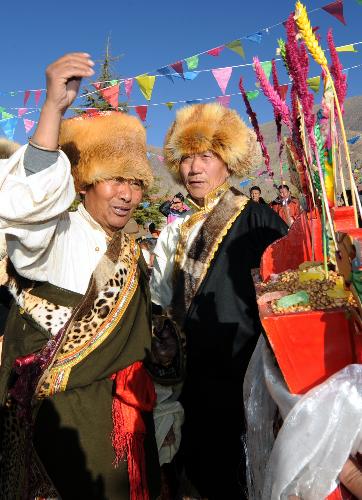 People of the Tibetan ethnic group attend a celebration for the lunar New Year of the Tiger according to the Tibetan calendar, in west Lhasa, capital of southwest China's Tibet Autonomous Region, Feb. 14, 2010