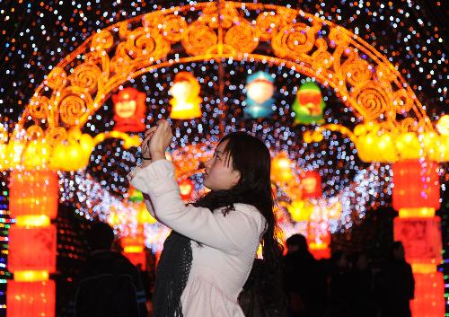 A visitor shoots colorful lanterns at a temple fair in Chengdu, capital of southwest China's Sichuan Province, Feb. 11, 2010. The temple fair kicked off Thursday and will last till March 3 for the Spring Festival celebrations.