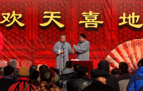 Actors perform traditional cross talk at the Ditan temple fair in Beijing, capital of China, Feb. 13, 2010. The temple fairs, or 'Miaohui' in Chinese, are usually held during Chinese Spring Festival to celebrate the traditional lunar New Year, which falls on Feb. 14 this year. 