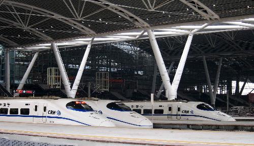 High-speed trains wait for departure at Guangzhou south railway station in Guangzhou, capital of south China's Guangdong Province, on Jan. 30, 2010. The Asia's biggest railway station came into use on Saturday, the first day of Chinese spring festival transport rush of 2010.