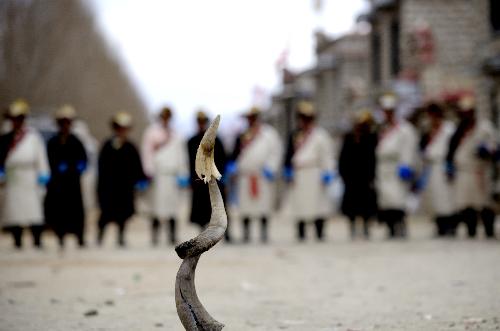 Tibetan villagers compete in a traditional game, in which participants try to shoot an oxhorn with stones, in a village of Lhasa, capital of southwest China's Tibet Autonomous Region, on Feb. 20, 2010.