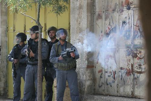 An Israeli soldier fires a tear gas canister at protestors during a demonstration in the West Bank city of Hebron, on Feb. 22, 2010.[