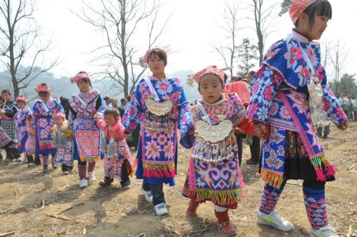 People of Miao ethic group in traditional clothes are seen on the annual traditional Tiaohua Festival at Jiupanjing village in Huaxi District in Guiyang, capital of southwest China's Guizhou Province, Feb. 22, 2010.