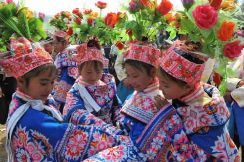 Children of Miao ethic group dance on the annual traditional Tiaohua Festival at Jiupanjing village in Huaxi District in Guiyang, capital of southwest China's Guizhou Province, Feb. 22, 2010.