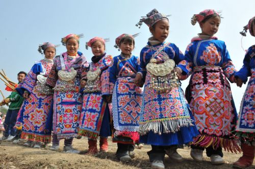 Children of Miao ethic group dance on the annual traditional Tiaohua Festival at Jiupanjing village in Huaxi District in Guiyang, capital of southwest China's Guizhou Province, Feb. 22, 2010.