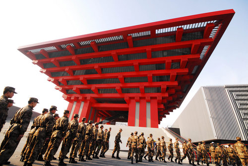 Armed police offi cers patrol yesterday in front of the China Pavilion for the upcoming Shanghai Expo.