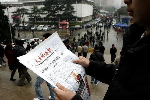 A job seeker looks for job information at a job fair held in Shanghai, China, Feb. 27, 2010.