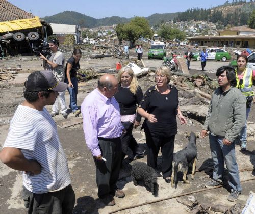 Chilean President Michelle Bachelet (front 2nd R) talks with people at the quake-hit area in Concepcion, Chile, Feb. 27, 2010. 