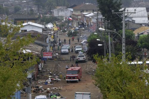 People walk on a street in earthquake-and-tsunami-devastated Dichato town, some 30 kilometers north of Concepcion, Chile, March 1, 2010. 