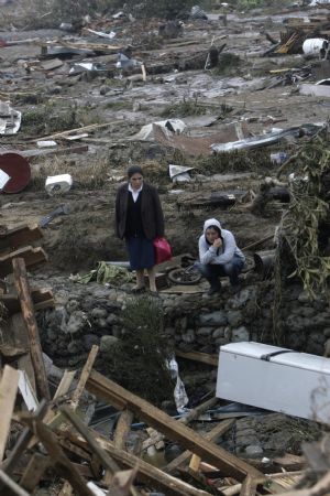 Women look for their relatives in earthquake-and-tsunami-devastated Dichato town, some 30 kilometers north of Concepcion, Chile, March 1, 2010.