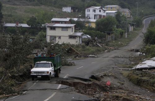 A truck travels on a damaged road in earthquake-and-tsunami-devastated Dichato town, some 30 kilometers north of Concepcion, Chile, March 1, 2010. 