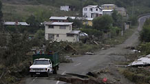 A truck travels on a damaged road in earthquake-and-tsunami-devastated Dichato town, some 30 kilometers north of Concepcion, Chile, March 1, 2010.