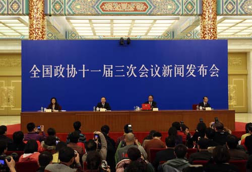 Zhao Qizheng (2nd, R), spokesman of the Third Session of the 11th Chinese People's Political Consultative Conference (CPPCC) National Committee, speaks during a news conference on the CPPCC session at the Great Hall of the People in Beijing, capital of China, March 2, 2010.