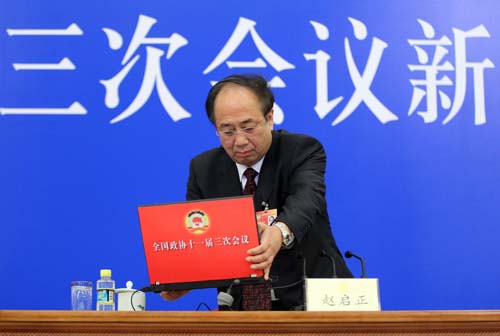 Zhao Qizheng, spokesman of the Third Session of the 11th Chinese People's Political Consultative Conference (CPPCC) National Committee, places a laptop before a news conference on the CPPCC session at the Great Hall of the People in Beijing, capital of China, March 2, 2010.