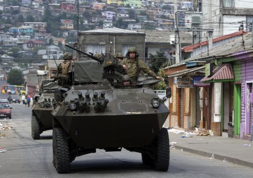 Military forces patrol on a road after tsunami and the 8.8-magnitude earthquake in Lota Port, 60km south Concepcion, Chile, March 2, 2010. 