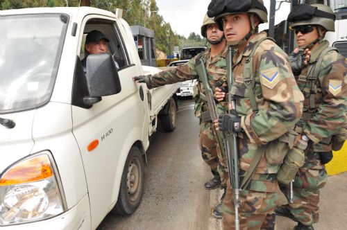 Soldiers check a car at a tolling station in Concepcion, Chile, March, 2, 2010. 
