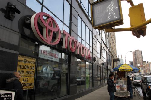 A pedestrian passes by a Toyota showroom in New York, March 2, 2010. It was announced on Monday that Toyota has informed more than 1 million American and Japanese customers of a fault that leads to an oil leak in Toyota vehicles. 