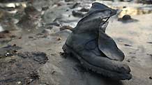 Photo taken on March 2 shows a shoe left behind by local people after a quake-triggered tsunami swept across Constitución in southern Chile on Feb. 27, 2010.