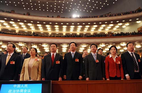 Members of the 11th National Committee of the Chinese People's Political Consultative Conference (CPPCC) sing the national anthem during the opening meeting of the Third Session of the 11th CPPCC National Committee at the Great Hall of the People in Beijing, capital of China, March 3, 2010.