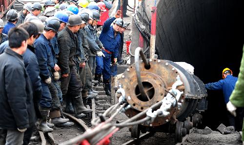 Rescue workers transport a pump in to a flooded pit of Luotuoshan Coal Mine in Wuhai City, north China's Inner Mongolia Autonomous Region, March 3, 2010. 