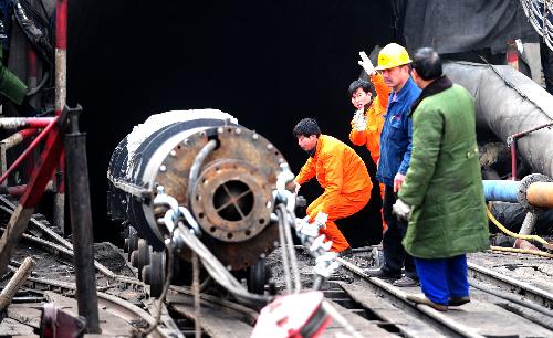 Rescue workers transport a pump in to a flooded pit of Luotuoshan Coal Mine in Wuhai City, north China's Inner Mongolia Autonomous Region, March 3, 2010.