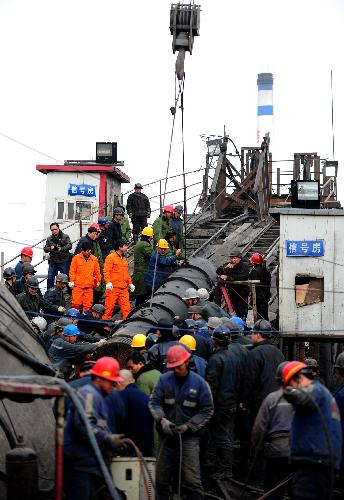 Rescue workers transport a pump in to a flooded pit of Luotuoshan Coal Mine in Wuhai City, north China's Inner Mongolia Autonomous Region, March 3, 2010.