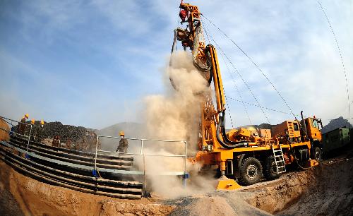 A drill digs holes into the Luotuoshan Coal Mine in Wuhai City, north China's Inner Mongolia Autonomous Region, March 3, 2010.