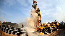 A drill digs holes into the Luotuoshan Coal Mine in Wuhai City, north China's Inner Mongolia Autonomous Region, March 3, 2010.