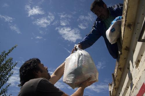 A worker delivers humanitarian materials in the quake-devastated Concepcion, Chile, March 3, 2010. 
