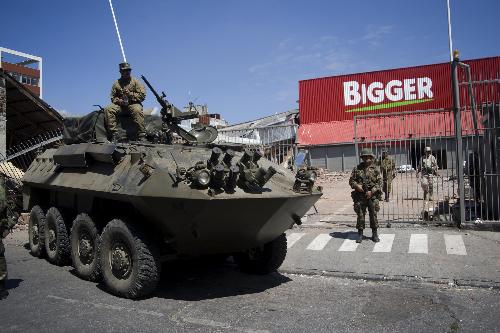 Chilian soldiers stand guard in a supermarket in the quake-devastated Concepcion, Chile, March 3, 2010. 