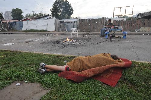 A homeless man sleeps in the open air in the suburb of quake-devastated Concepcion, Chile, March 3, 2010. 